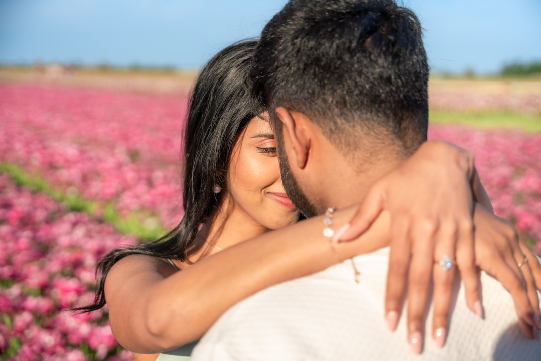 Sheffinea showing her engagement ring to the camera during a close embrace