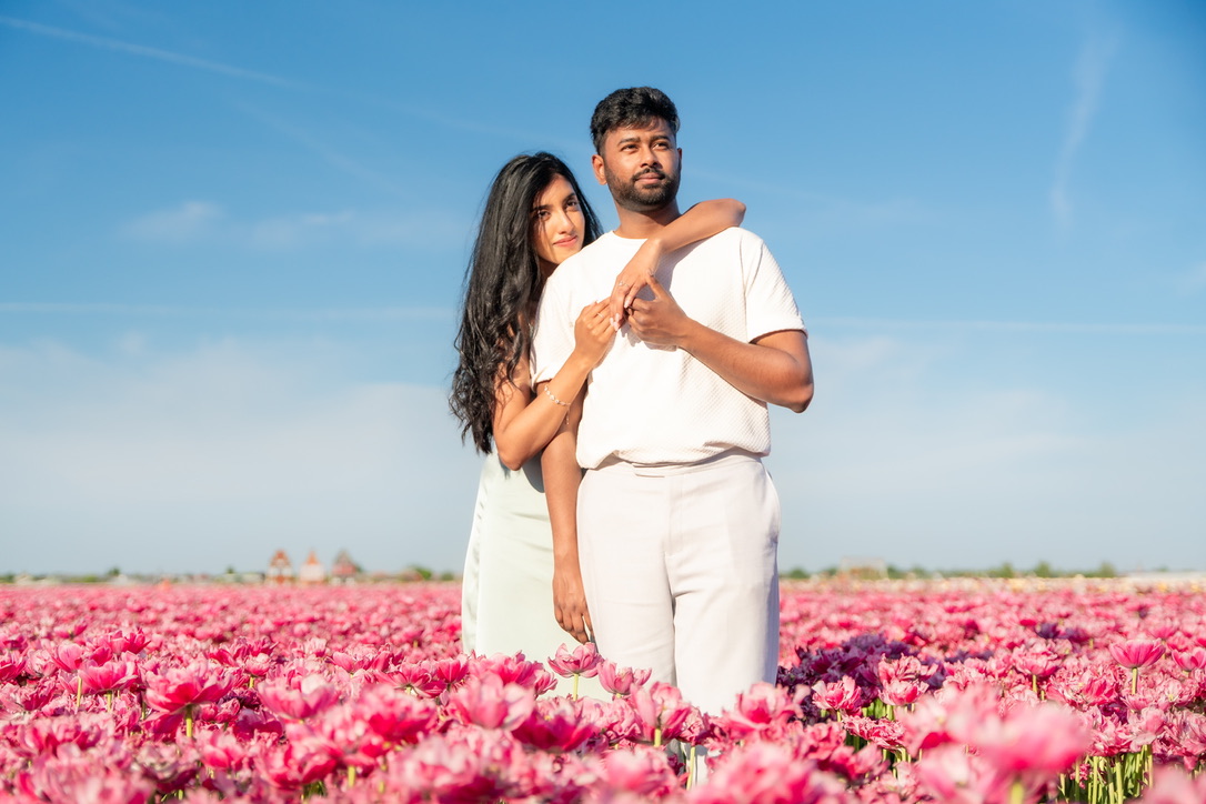 Shajeethan and Sheffinea posing together among pink tulips