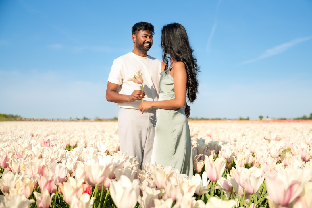 Shajeethan and Sheffinea standing together among white tulips